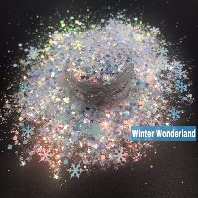 A glitter mix with predominantly silver and white colors, shaped glitter pieces forming snowflakes, intended for a winter wonderland themed aesthetic.